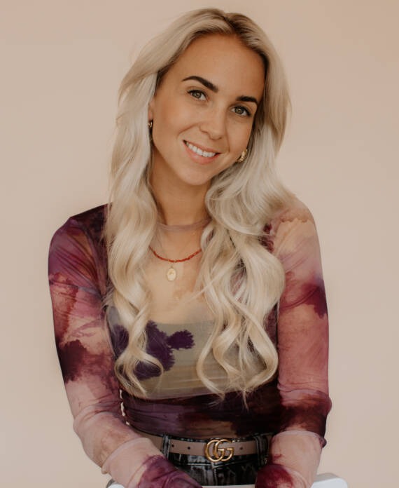 Esmee, fotograaf van Studio Samsam, met blond golvend haar in een gekleurde top.